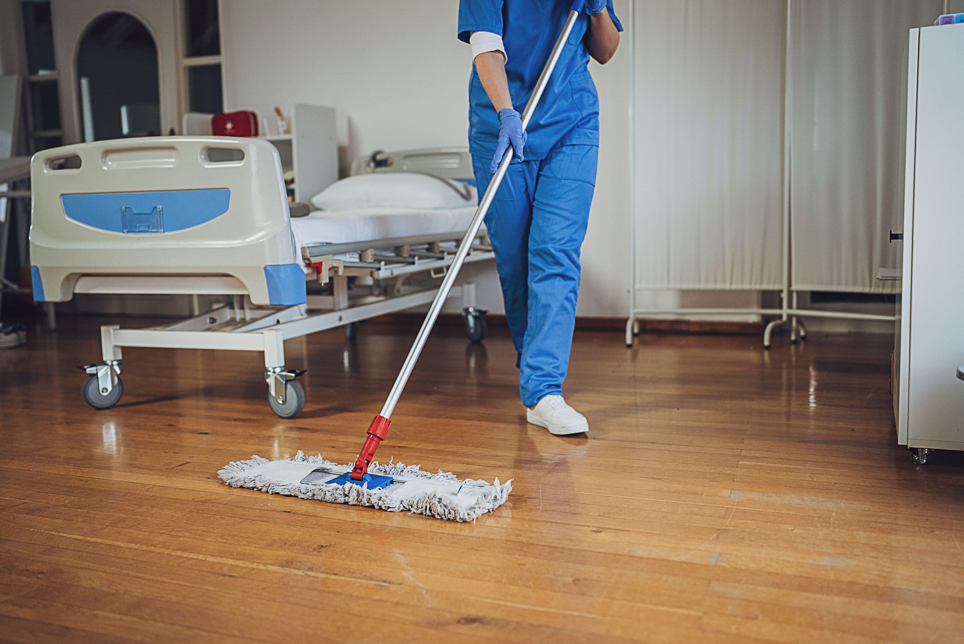 Woman mopping floor at the hospital ward